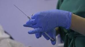 the syringe in the doctor's hands